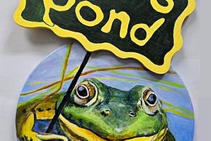hand painted sign of a bullfrog holding a sign